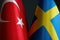 Close-up of the flags of Sweden and Turkey.