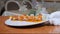 Close-up of Flambe Style Dish of tiger shrimp on a plate being served in restaurant by waiter in gloves. Smoke Slow