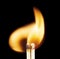 Close-up of the flame coming from two ignited matchsticks ignited against black background