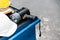 Close-up of flashlight and safety helmet on steel movable garage storage cabinet. Auto car repair service center.