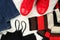 Close up, flat lay of casual clothing details for women - blue jeans, red sneakers, black sleeveless tank top and multicolored,