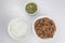  close up flat lay top view shot of a bowl of sliced beef fillet pieces, a plate of cellophane glass noodles and a cup of