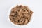 close up flat lay top view shot of sliced beef fillet pieces in a white bowl on a white background