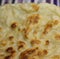Close up of flat slices of baked roti bread on blurred background
