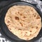 Close up of flat slices of baked roti bread on plate