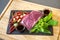 Close up from flatlay, top table view of Raw Beef herb ingredients, basil, garlic, chilli, sauces on black slate plate for Thai