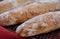 Close up of floury home made ciabatta sour dough loaves cooling on a wire tray, baked during the Coronavirus lockdown.