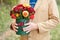 Close-up flower-box in man hands as a gift concept for wedding, birthday, event, celebration, flowers delivery, surprise