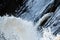 close up of flowing water, rapid water splashes of an white water river or stream, bubbly water