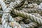 Close up fo a large pile of very old, natural fiber, thick rope