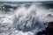 close-up of foaming waves pounding the shore during a tsunami