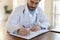 Close up focused doctor wearing uniform working with documents