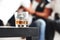 Close up focused photo of glass with whiskey standing on the black table with blurred people on the background