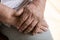 Close up folded together hands of elderly man