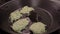 CLOSE UP FOOD: frying zucchini pancake at hot pan