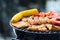 Close up of food grilling on a charcoal kettle grill