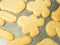 A close up food photograph of a variety of baked golden brown sugar Christmas cookies in various shapes including gingerbread man