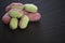 Close up food photography of candy sweets in red and green colors and flavored with apple blackcurrent on dark slate background