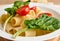 Close-up food photography of a vegetarian uncooked traditional Italian whole wheat pasta - tortiglioni with halves of tomato and