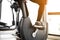 Close up foot biking in gym, exercising legs doing cardio workout cycling bikes