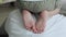 A close-up of the foot of a little boy who climbed onto his father`s back. Time with the kids. Family traditions. A