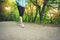 Close-up of a foot of a sporty girl in leggings and sneakers before jogging in the forest. The concept of outdoor sports