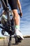 Close-up of the foot of a young man cycling.