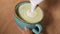 Close up footage of barista making latte art with green matcha, vegan latte