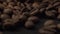 Close up footage of coffee beans falling on black table spinning around. Macro shot of fresh raw coffee.