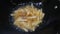 Close up footage, frying french fries using black pan,