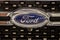Close up of the Ford car brand logo on dark background