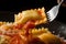 Close-up of a fork twirling a single ravioli pasta coated in a rich tomato sauce