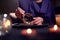 Close-up of fortuneteller& x27;s hands divining on coffee grounds at table with predictive ball