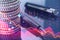 Close up of fountain pen and stacked coins on table with pink crisis business and forex chart on blurry background with bokeh