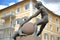 Close-up on a fountain with statues of children, located in front of St Antonio Chapel in Ortisei, Val Gardena