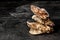 Close-up of four beautiful close oysters on a black background. Delicious tropical sea mollusk. The greatest delicacy. Copy space.