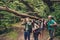 CLose up of four best friends, walking in autumn forest, amazed by the beauty of nature, wearing comfortable outfits for hiking,