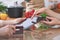 Close-up of four human hands are gesticulate over a tablet in the kitchen. Friends having fun while choosing menu or