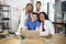 Close up of four international doctors with gadgets at modern office in clinic