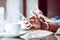 Close up of four people hands holding mobile phone and using internet