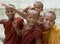 Close up of four young novice monks laughing and having fun, Myanmar