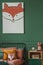 Close-up of a fox painting on a green wall above an orange and black bed for a child in a bedroom interior with plush fox toys.