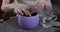 close-up of fragile female hands carefully planting a plant in a pot at home