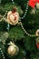 Close up. A fragment of a Christmas tree, holiday toys and garlands decorate the Christmas tree in the background