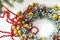 Close-up of a fragment of a Christmas wreath with red beads on a white background