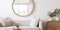 Close up framed mirror on the white wall above wooden table with home decor pieces. Interior design of modern room