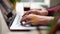 Close up of freelancer's developer hands typing program code on laptop keyboard in coworking. Businessman at work in