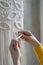 Close up of freelancer woman working on half-finished macrame piece, weaves lamp shade for chandelier. Women hobby