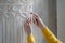 Close up of freelancer woman working on half-finished macrame piece, weaves lamp shade for chandelier. Women hobby