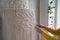 Close up of freelancer woman working on half-finished macrame piece, weaves lamp shade for chandelier. Women hobby